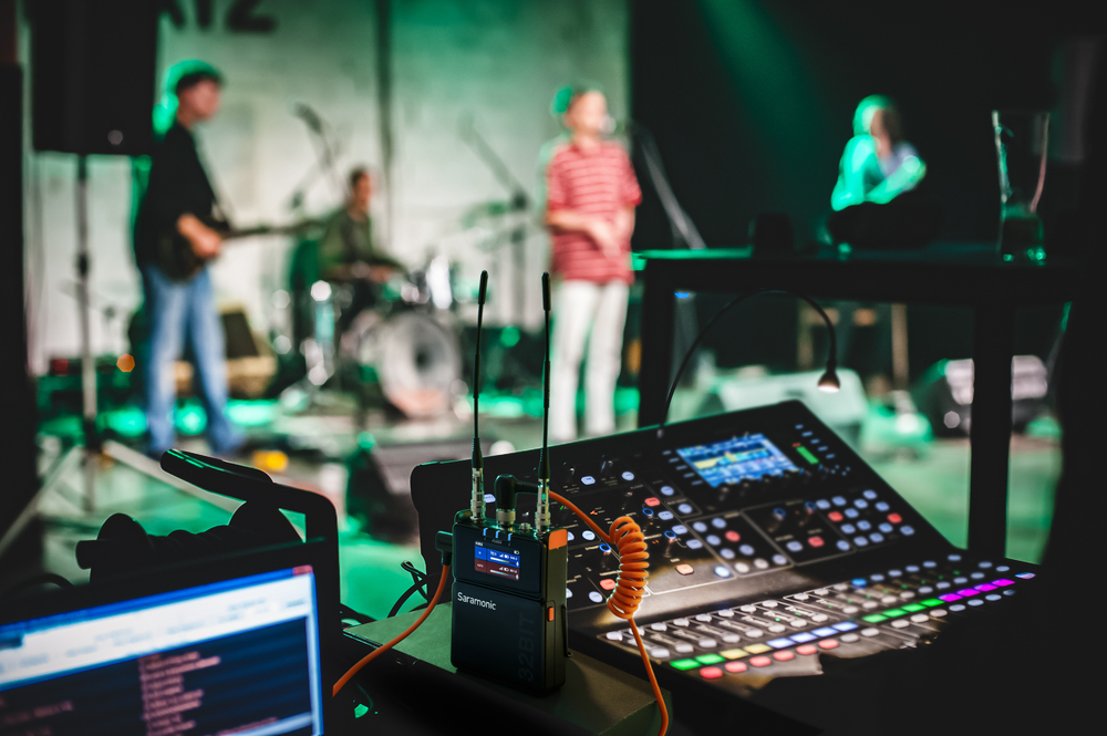 Saramonic 32-bit wireless receiver system in live performance setup with mixing console.