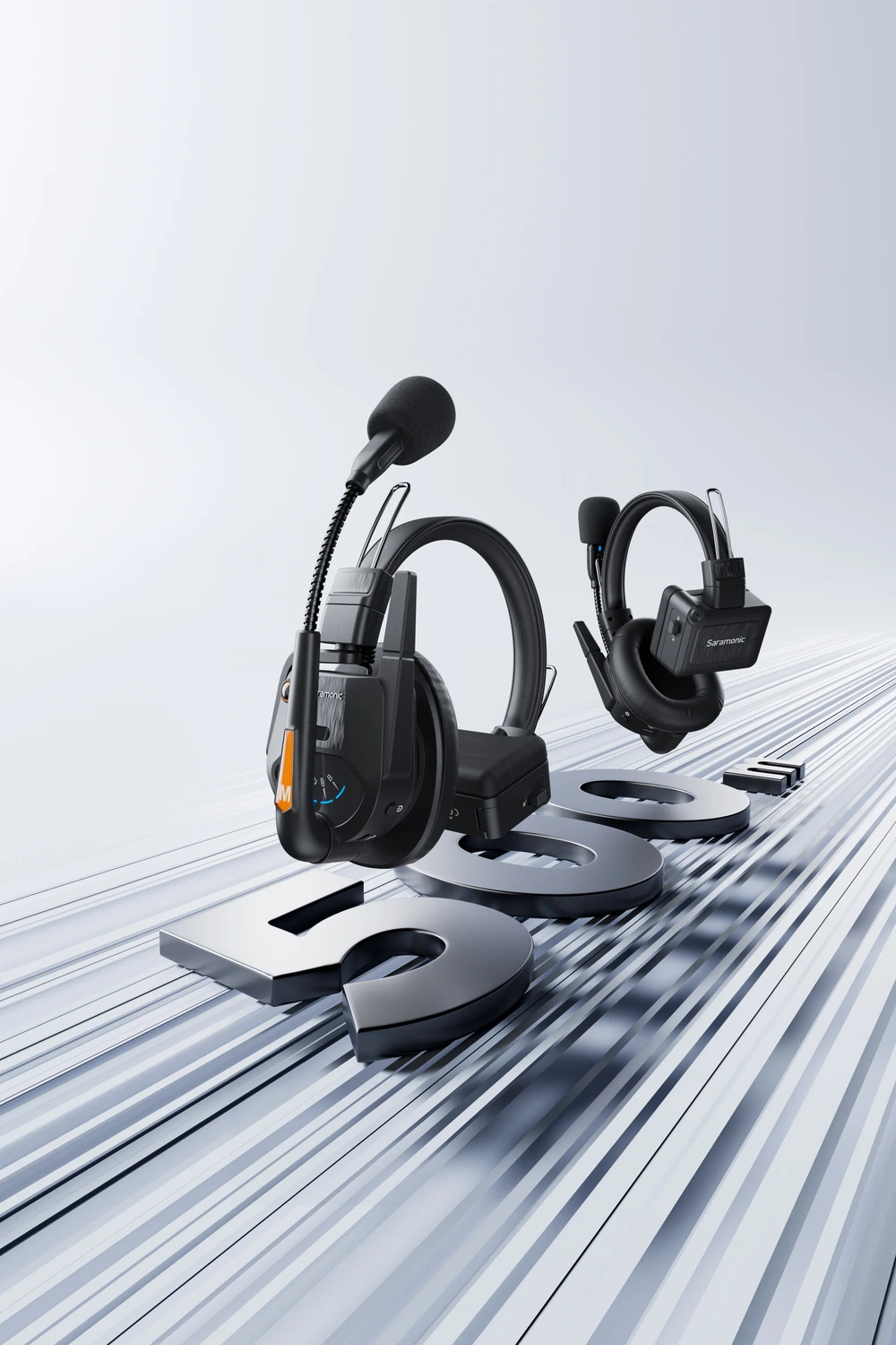 Saramonic wireless communication headsets with microphones, positioned over large metallic letters.